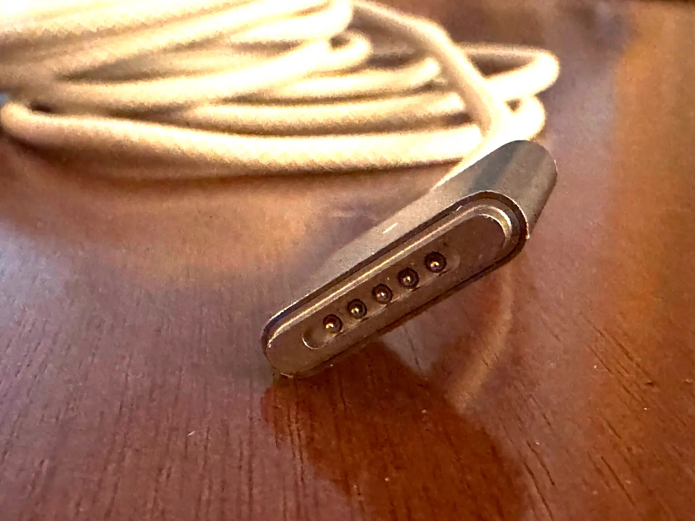 A MagSafe 3 connector with its braided cable